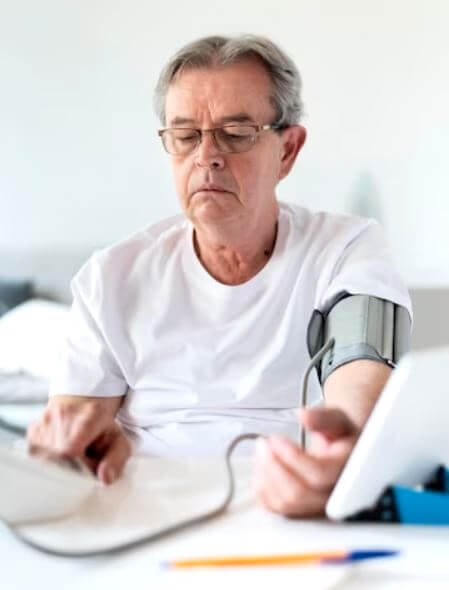 Homme de 60 ans mesurant sa tension artérielle